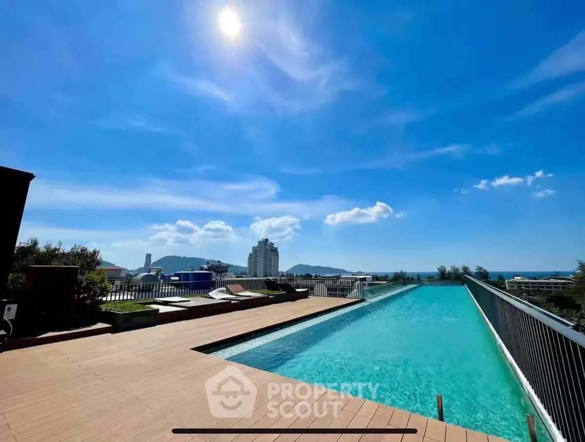 Stunning rooftop pool with panoramic city and ocean views under a clear blue sky.