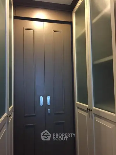 Stylish storage space with elegant cabinetry and sliding doors in modern home.