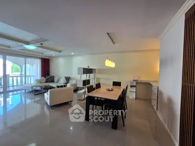 Spacious open-plan living and dining area with modern furnishings and ample natural light.
