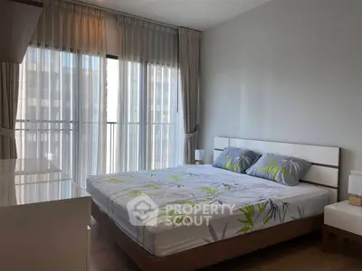 Modern bedroom with large windows and stylish decor in a high-rise apartment.