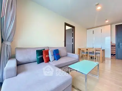 Modern living room with cozy sofa and dining area in open layout apartment.