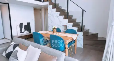 Modern duplex living room with stylish staircase and elegant dining area