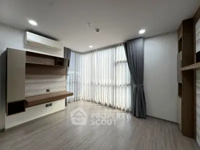 Spacious modern living room with large windows and elegant curtains