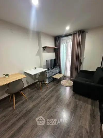 Modern living room with sleek furniture and natural light, perfect for cozy urban living.