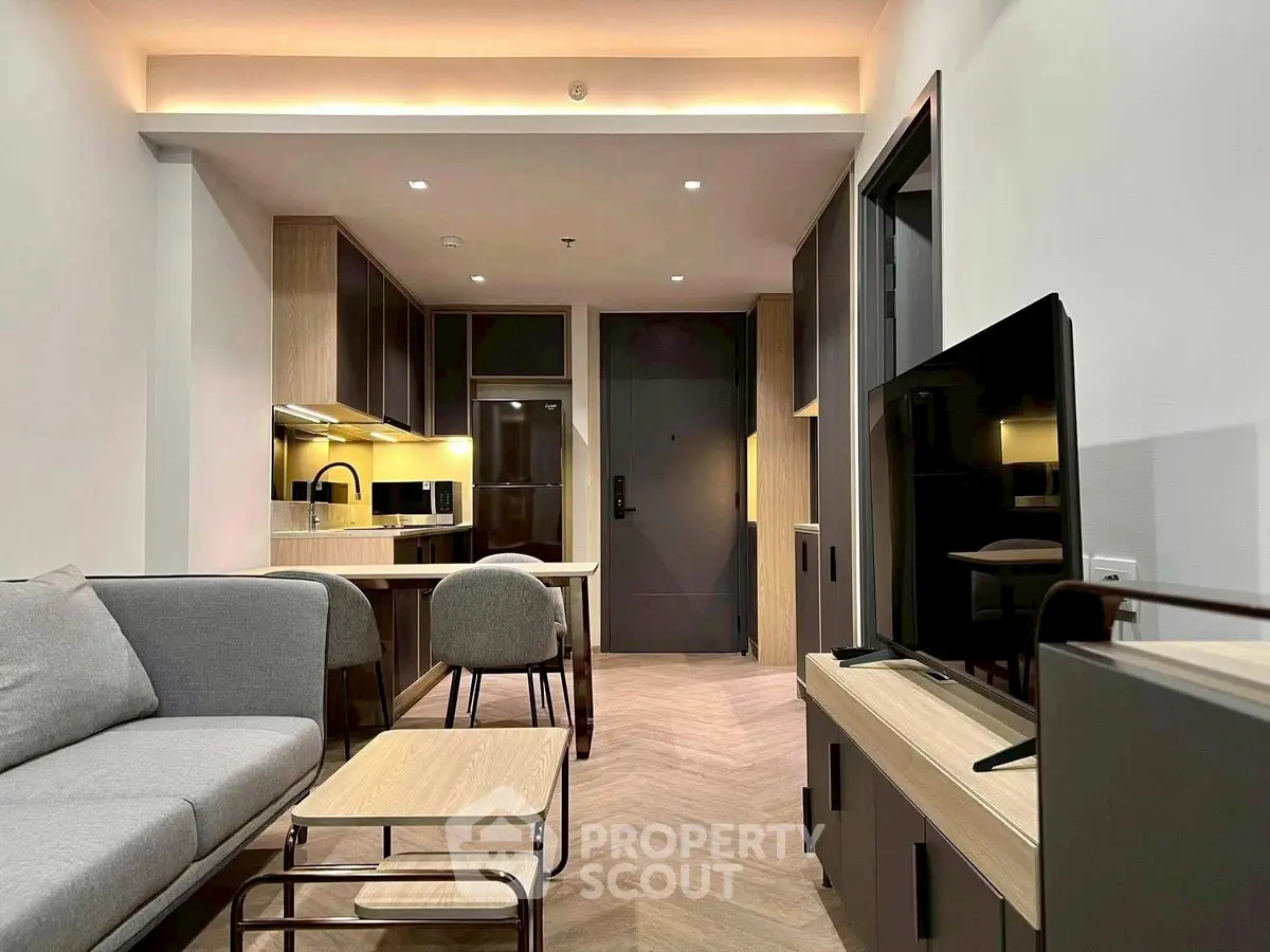 Modern living room with sleek furniture and open kitchen layout, perfect for contemporary urban living.