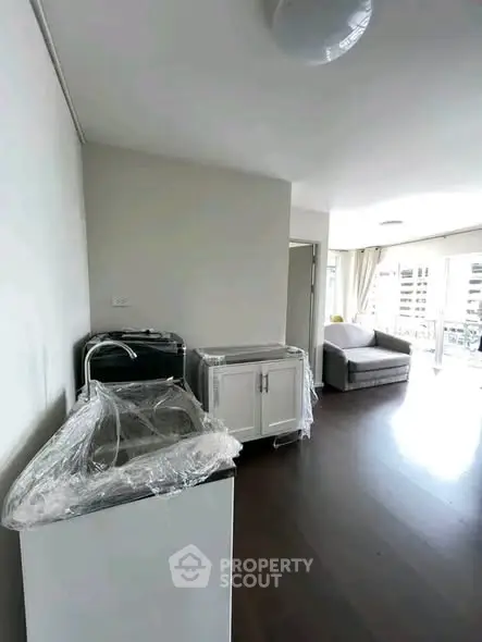 Spacious living room with modern furniture and large windows for natural light.