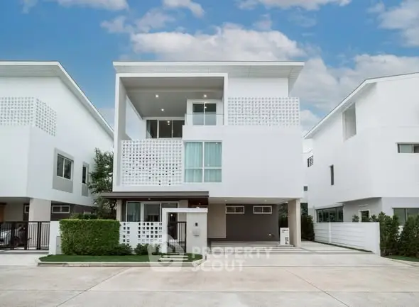 Modern minimalist white house with clean lines and spacious driveway