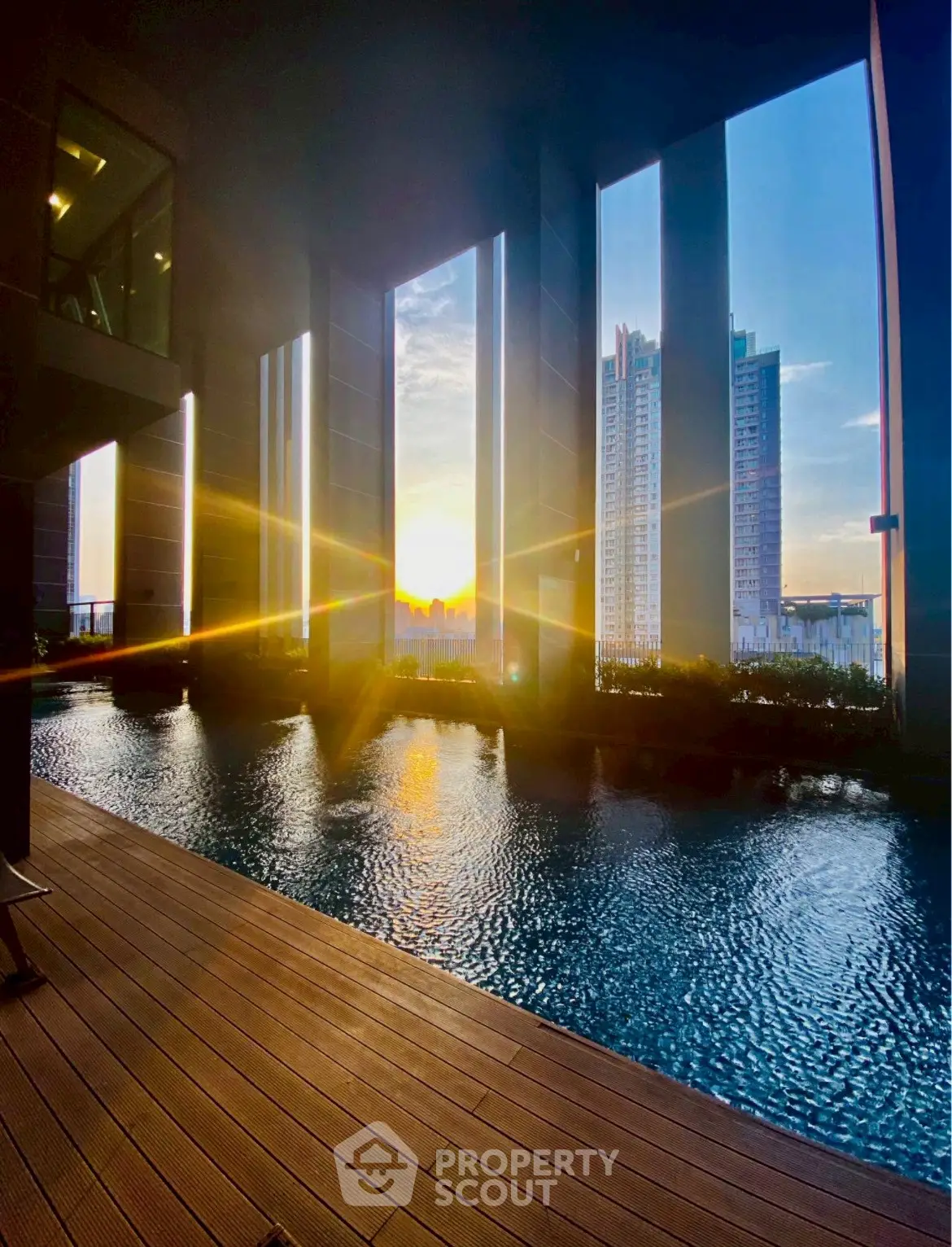 Luxurious high-rise pool with stunning sunset view and modern architecture.