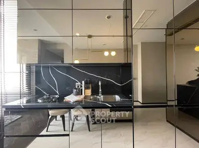 Modern kitchen with sleek black marble countertops and stylish dining area
