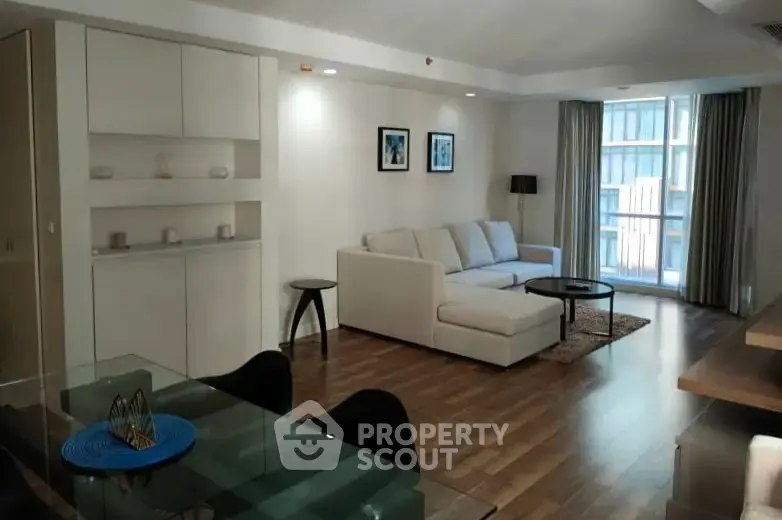 Spacious modern living room with elegant decor and large windows in a luxury apartment.