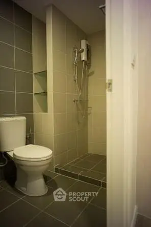 Modern bathroom with sleek shower and toilet in contemporary design.