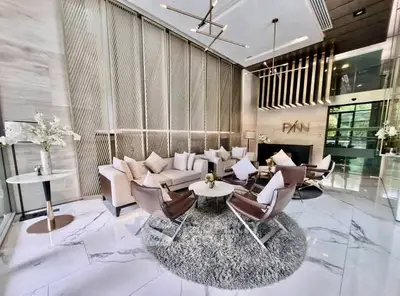 Luxurious modern living room with elegant decor and high ceilings in a sophisticated apartment building.