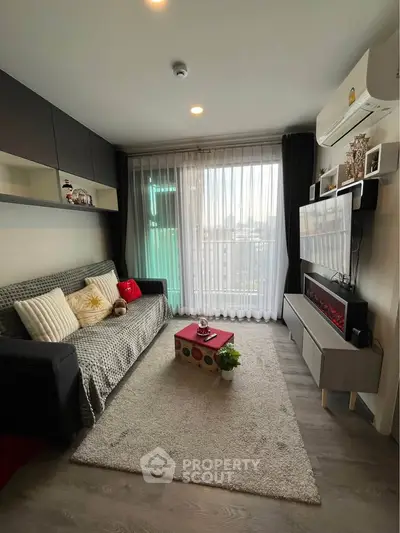 Cozy living room with modern decor, large window, and stylish furniture.