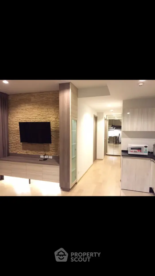 Modern apartment interior with stylish living room and kitchen area, featuring sleek design and cozy ambiance.