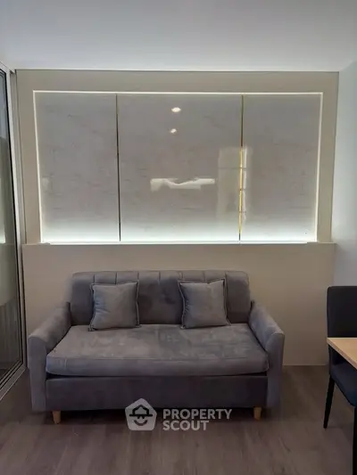 Modern living room with stylish gray sofa and elegant marble accent wall