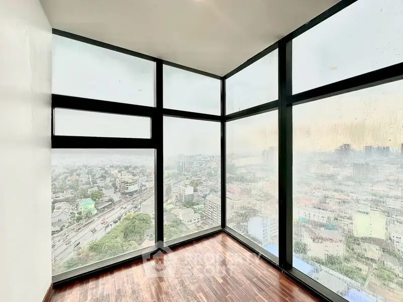 Stunning corner unit with panoramic city views through floor-to-ceiling windows.