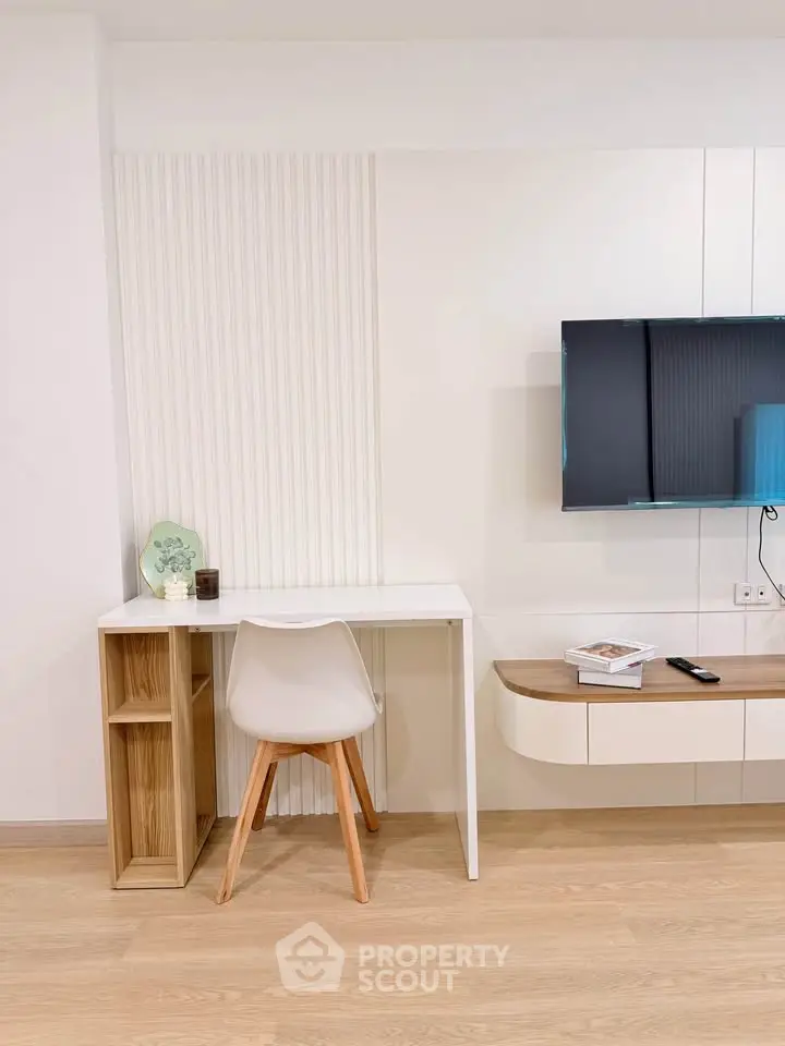 Modern living room with sleek TV setup and minimalist desk area