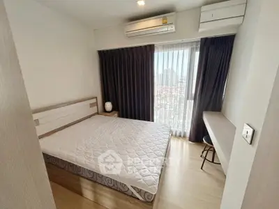 Modern bedroom with city view, featuring a cozy bed, air conditioning, and stylish furnishings.