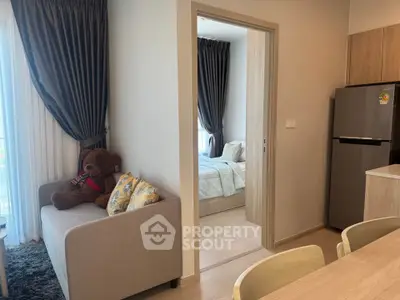 Cozy modern apartment with open living area and bedroom view, featuring stylish decor and natural light.