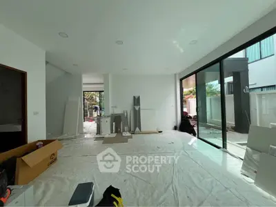 Spacious modern living room with large windows and natural light