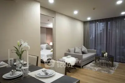 Modern open-plan living room with elegant dining area and cozy bedroom view.