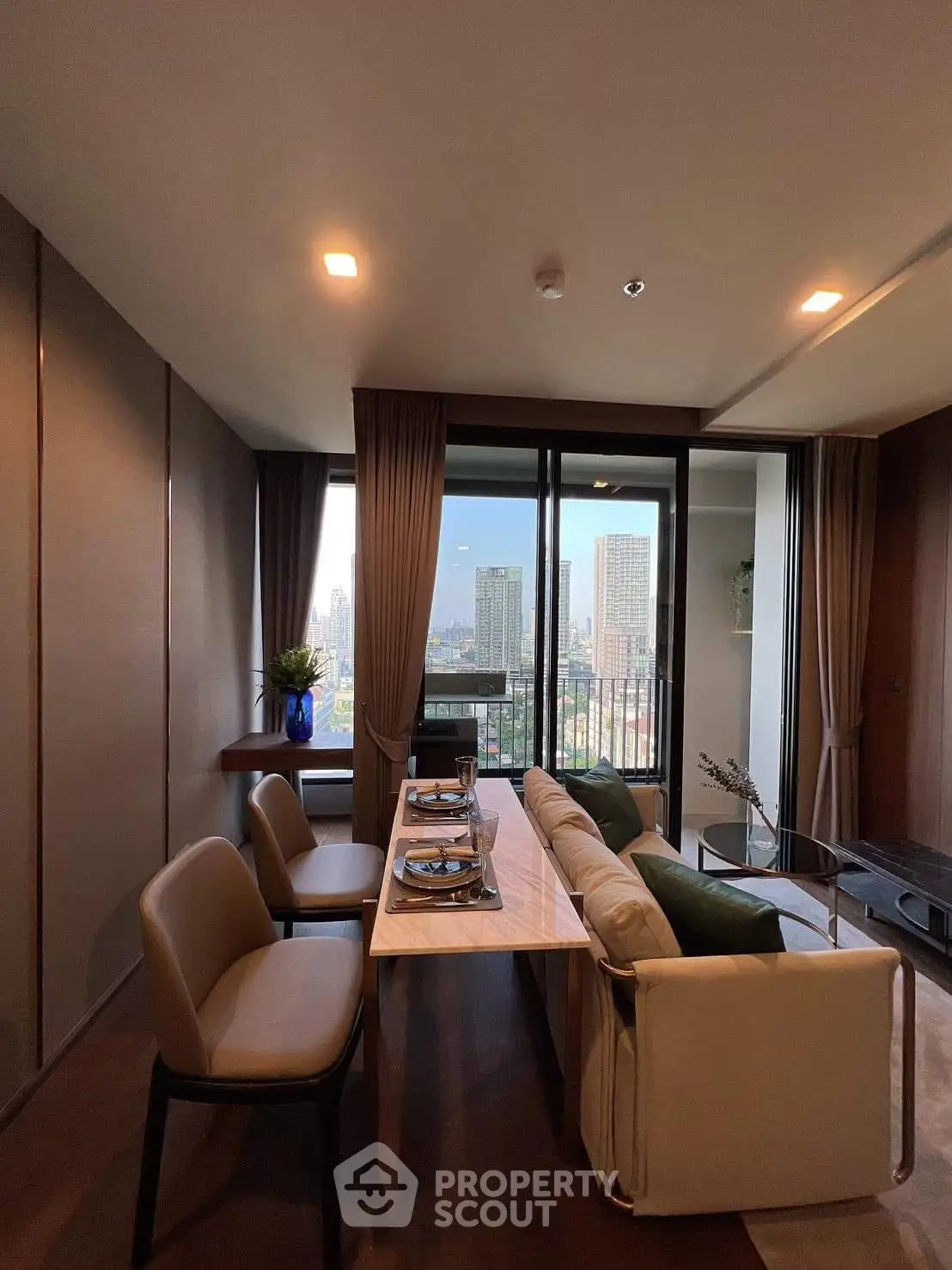 Luxurious dining area with city view, elegant decor, and modern furnishings.