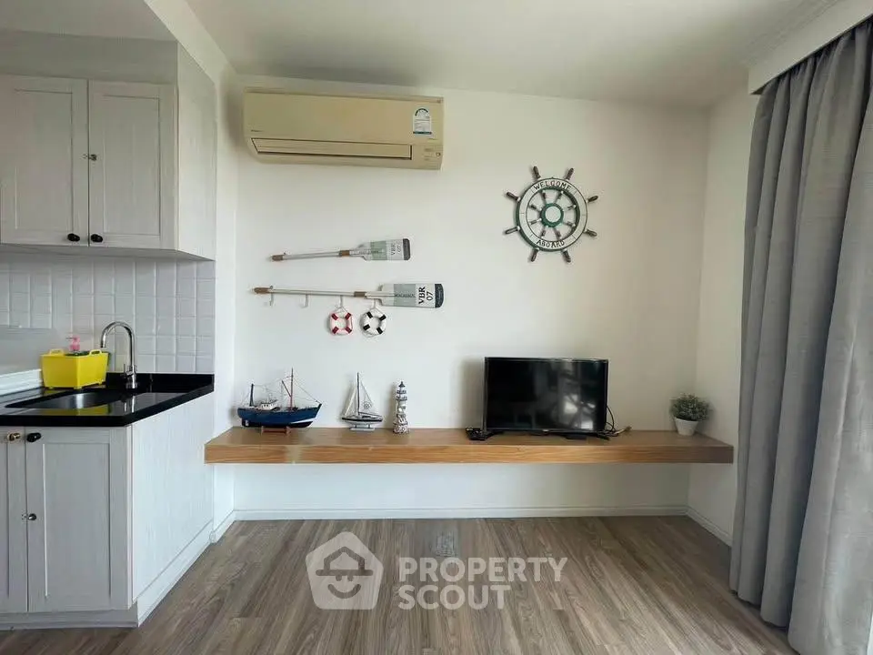 Charming living room with nautical decor and modern amenities, perfect for cozy living.