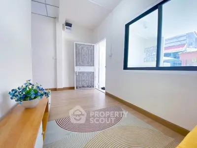 Bright and airy room with modern decor and large window view.