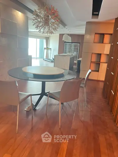 Modern dining area with stylish chandelier and open kitchen layout