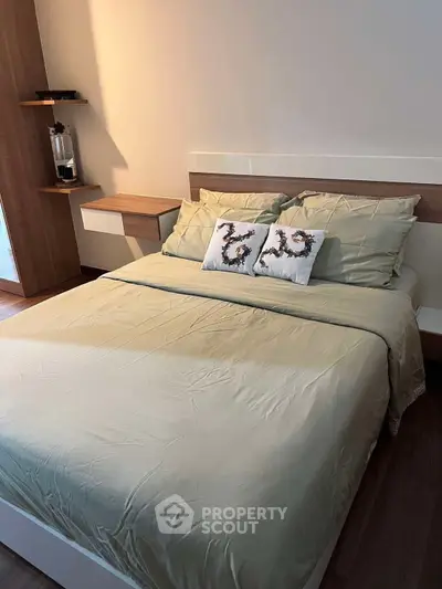 Cozy bedroom with modern decor and comfortable bedding in a stylish apartment.