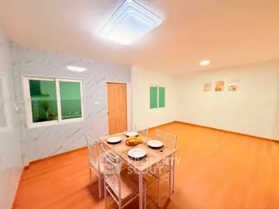 Spacious dining area with modern lighting and wooden flooring