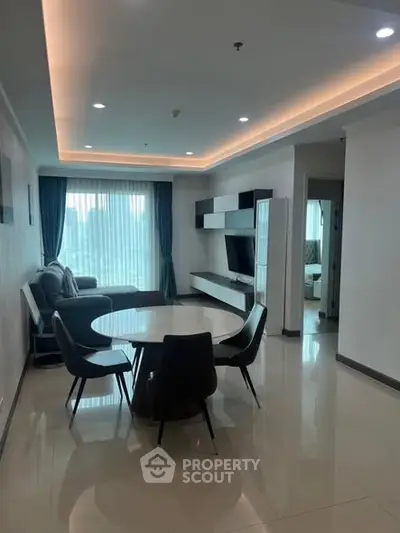 Modern living room with sleek furniture and large windows in a stylish apartment.