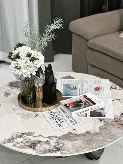 Elegant living room with stylish marble coffee table and chic decor accents.
