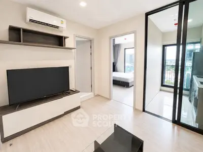 Modern apartment interior with open living room, bedroom, and balcony view.