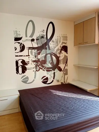 Modern bedroom with unique musical-themed wall art and built-in storage solutions.