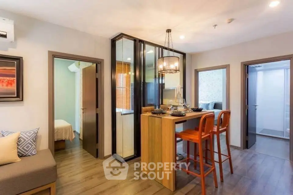 Modern apartment interior with stylish dining area and cozy bedroom view.