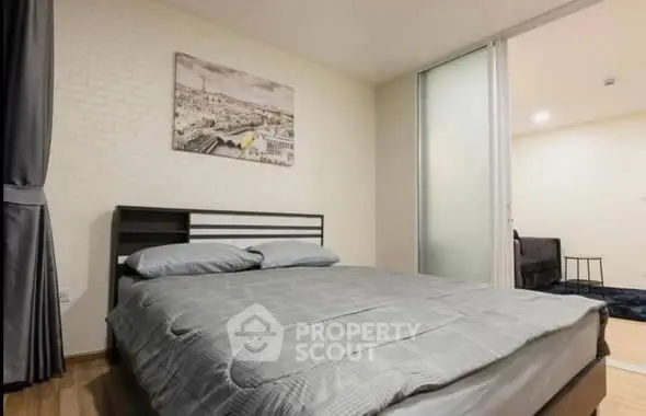 Modern bedroom with cozy bed and stylish decor in a contemporary apartment.