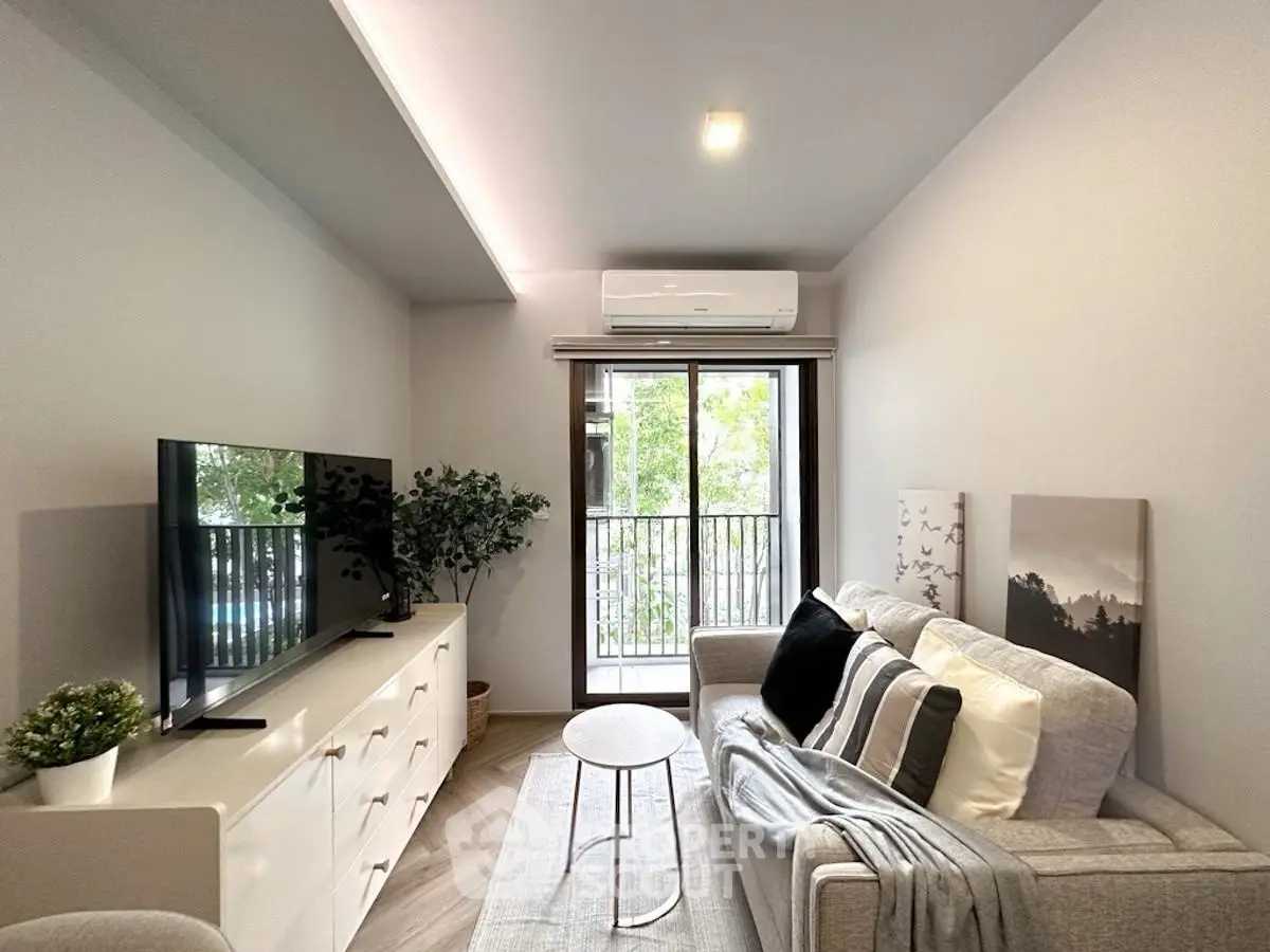 Modern living room with sleek furniture and large window for natural light.