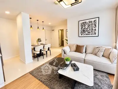 Modern living room with stylish decor and open dining area, perfect for contemporary living.