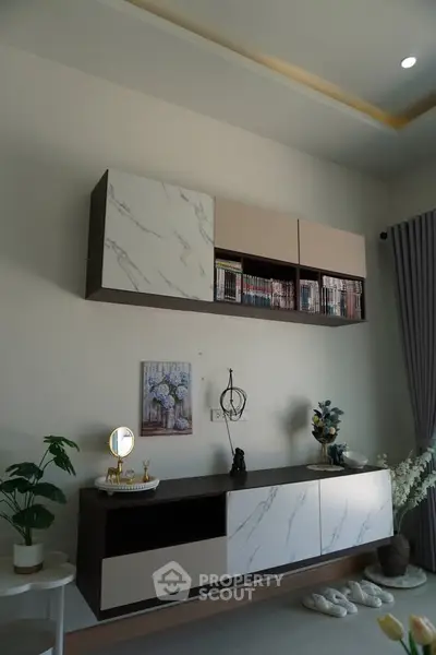 Modern living room with stylish wall cabinets and decor