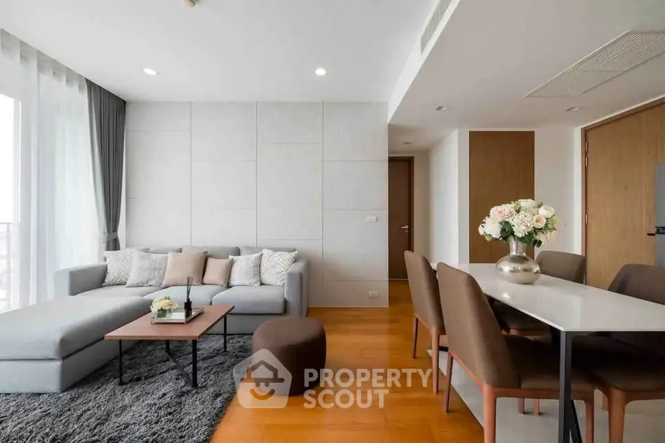 Modern living room with stylish decor and dining area, featuring a cozy sofa and elegant dining table.