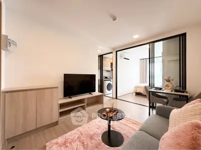 Modern living room with cozy decor and open layout in a stylish apartment.