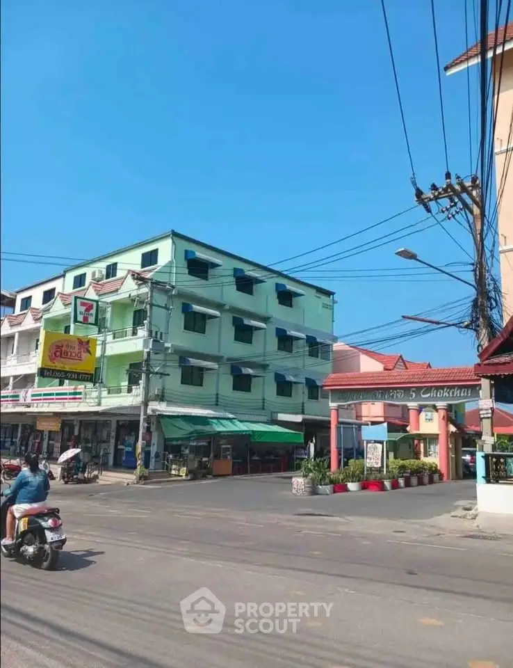 Street view of a vibrant urban neighborhood with colorful buildings and local shops.