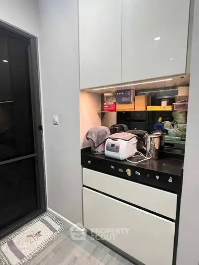 Modern kitchen with sleek cabinetry and appliances, featuring a compact yet functional design.