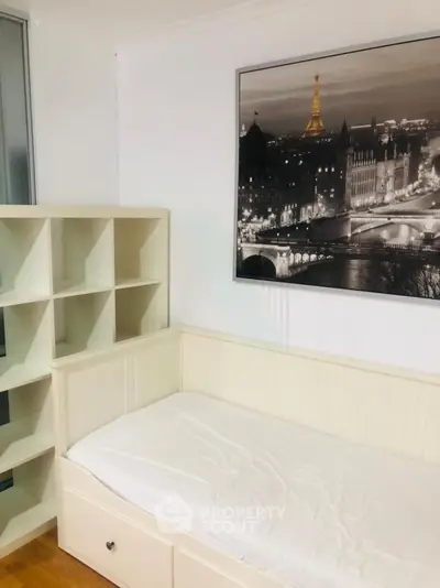 Cozy bedroom with stylish shelving and elegant wall art