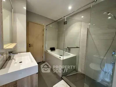 Modern bathroom with glass shower and bathtub in sleek design