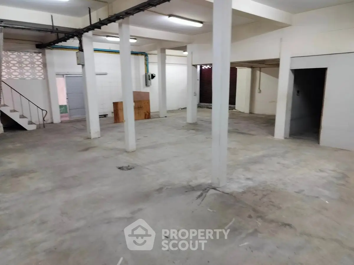 Spacious basement area with concrete flooring and open layout, ideal for storage or workshop use.