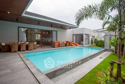 Luxurious modern villa with private pool and stylish outdoor seating area.