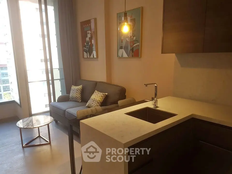 Modern living room with stylish decor and open kitchen layout in a bright apartment.