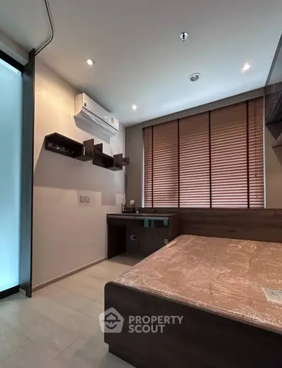 Modern bedroom with sleek design, featuring wooden bed and shelves, air conditioning, and natural light.